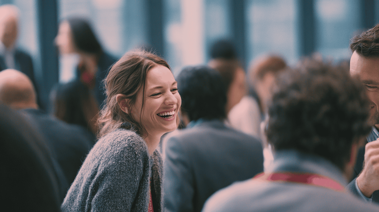 attendees-at-an-education-conference Attendees mill about in a conference hall networking at an education conference.